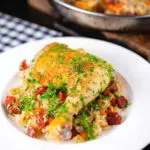 Spanish-influenced baked chicken and chorizo rice served on a plate.