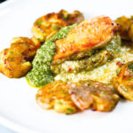 Baked pesto and mozzarella stuffed chicken breast with crushed roasted new potatoes.