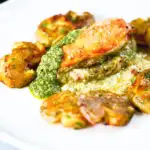 Baked pesto and mozzarella stuffed chicken breast with crushed roasted new potatoes.