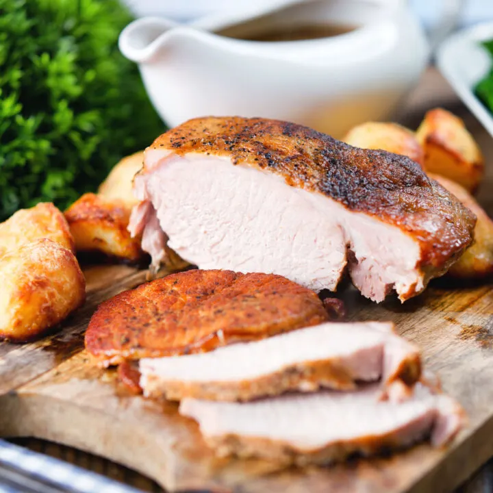Carved slow cooker pork loin, with a gravy, and roast potatoes.