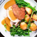 Slow cooker pork loin served with roast potatoes, vegetables and a cider, mustard and honey gravy.