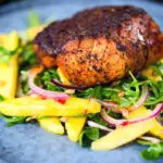 Pan-fried Cajun Blackened cod fish served with mango salad.