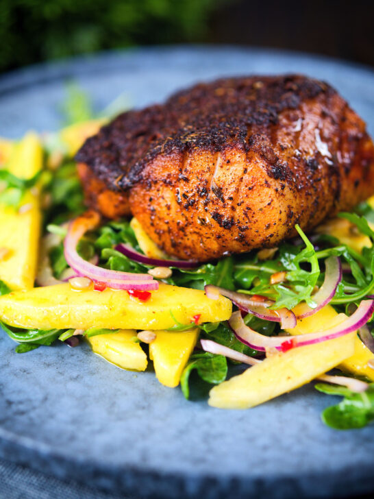 Pan-fried Cajun Blackened cod fish served with mango salad.