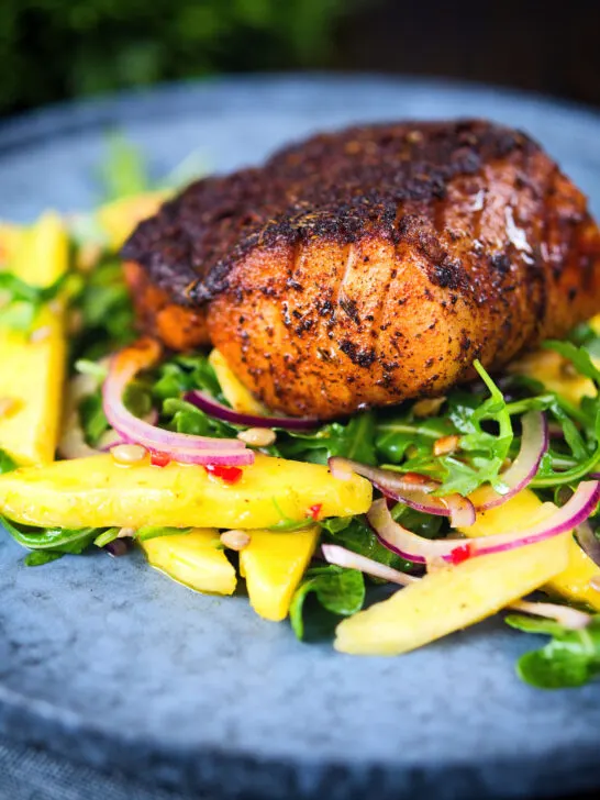 Pan-fried Cajun Blackened cod fish served with mango salad.
