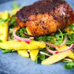 Pan-fried Cajun Blackened cod fish served with mango salad.