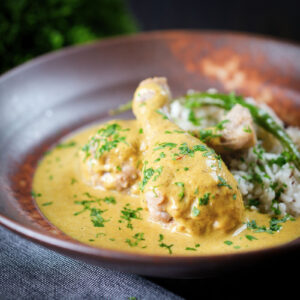 Bengali chicken rezala curry served with jeera rice and green chilli.