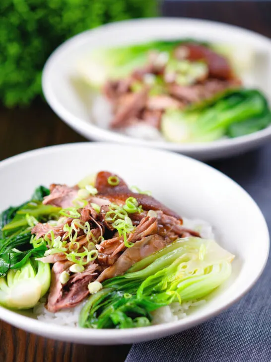Shredded braised Chinese pork knuckle with rice and steamed pak choi.