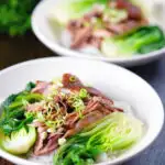 Shredded braised Chinese pork knuckle with rice and steamed pak choi.