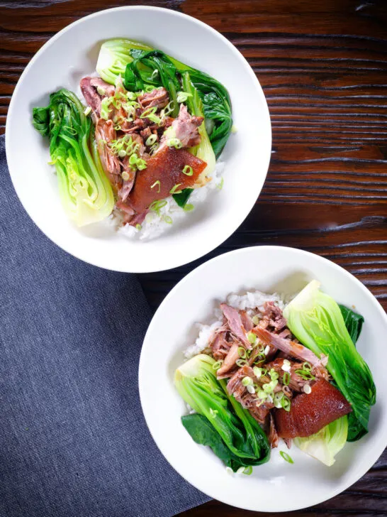 Overhead shredded braised Chinese pork knuckle with rice and steamed pak choi.