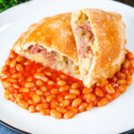 Homemade corned beef, onion and potato pasty served with baked beans.