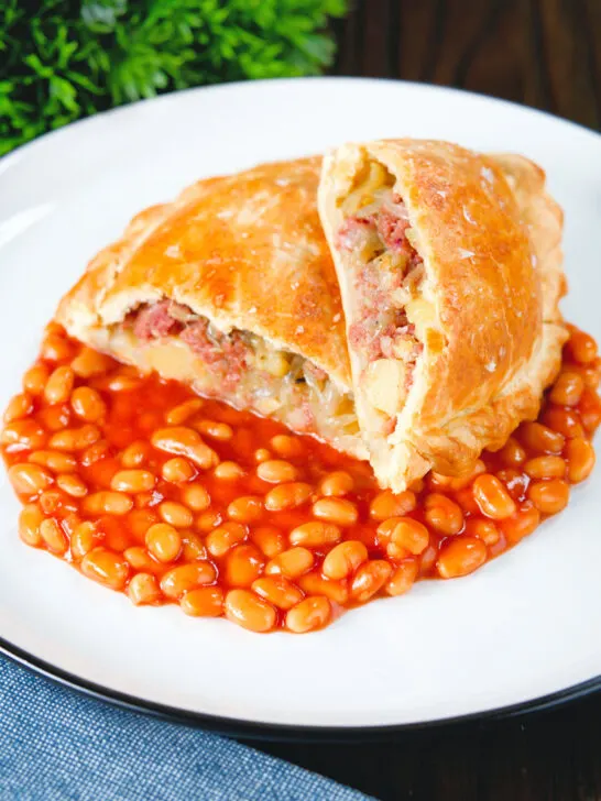 Homemade corned beef, onion and potato pasty served with baked beans.