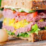 Canned corned beef sandwich with piccalilli on wholegrain seeded bread.