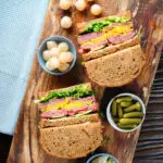 Overhead canned corned beef sandwich with piccalilli on wholegrain seeded bread.