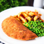 Homemade minced beef filled crispy pancakes served with chips, peas and gravy.