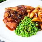 Cut-open minced beef filled crispy pancakes served with chips, peas and gravy.