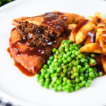 Cut-open minced beef filled crispy pancakes served with chips, peas and gravy.