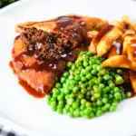 Cut-open minced beef filled crispy pancakes served with chips, peas and gravy.