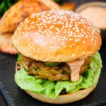 Fish burger with Thai flavours topped with sriracha mayonnaise and cucumber.