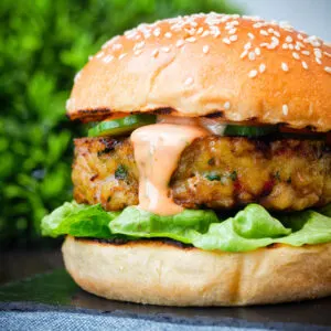 Cod fish burger with Thai flavours topped with sriracha mayonnaise and cucumber.
