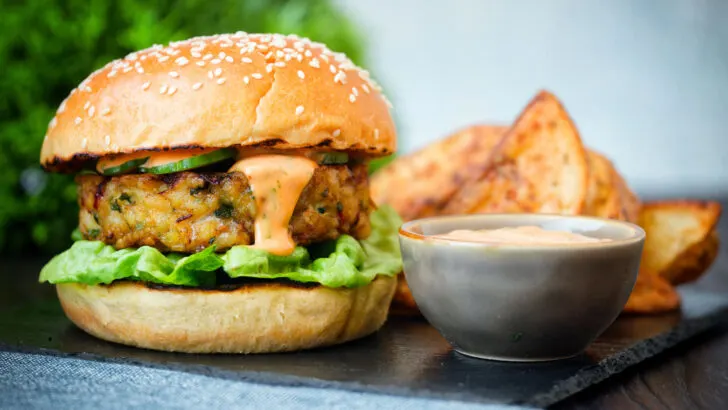 Cod fish burger with Thai flavours topped with sriracha mayonnaise and cucumber.
