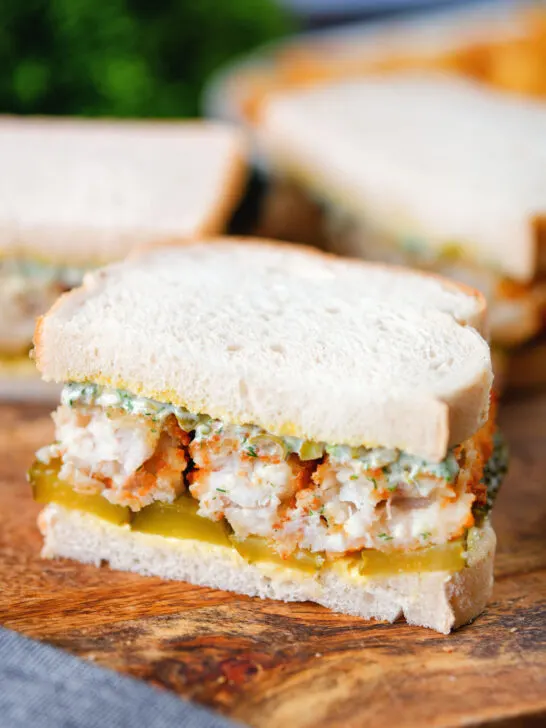 Fish finger sandwich with homemade tartar sauce and gherkins.