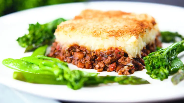 French Hachis Parmentier (cottage pie) served with sauteed green vegetables.