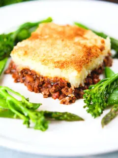 French Hachis Parmentier with a mashed potato & breadcrumb topping and green vegetables.