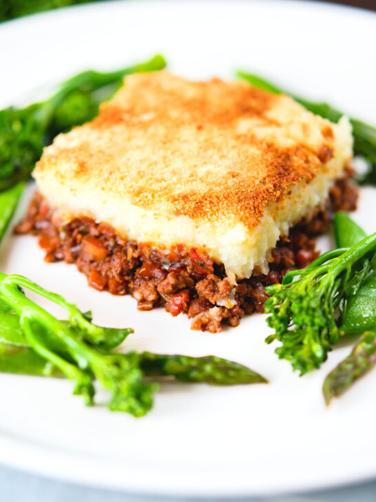 French Hachis Parmentier with a mashed potato & breadcrumb topping and green vegetables.