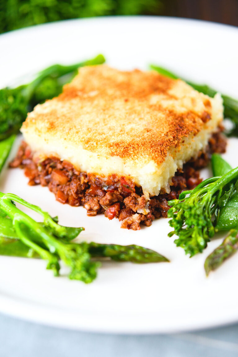 French Hachis Parmentier with a mashed potato & breadcrumb topping and green vegetables.