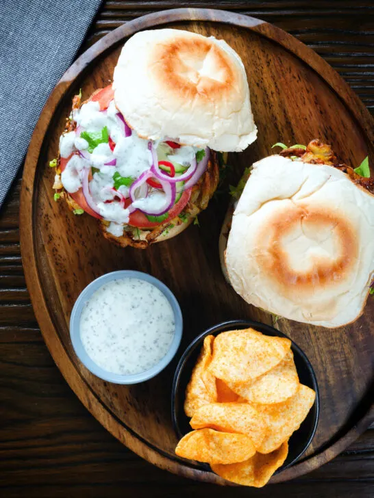 Overhead bhaji burger with tomato, cucumber, red onion, chilli and a mint raita style sauce.