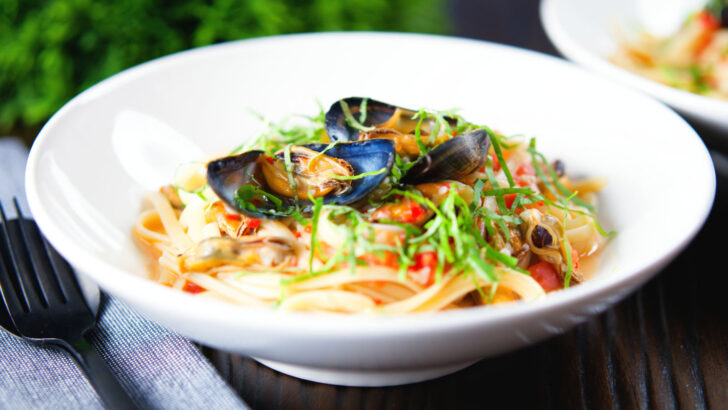 Pasta (linguine) with mussels in white wine with garlic, chilli and tomatoes.