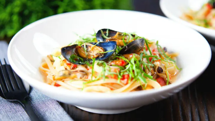 Pasta (linguine) with mussels in white wine with garlic, chilli and tomatoes.