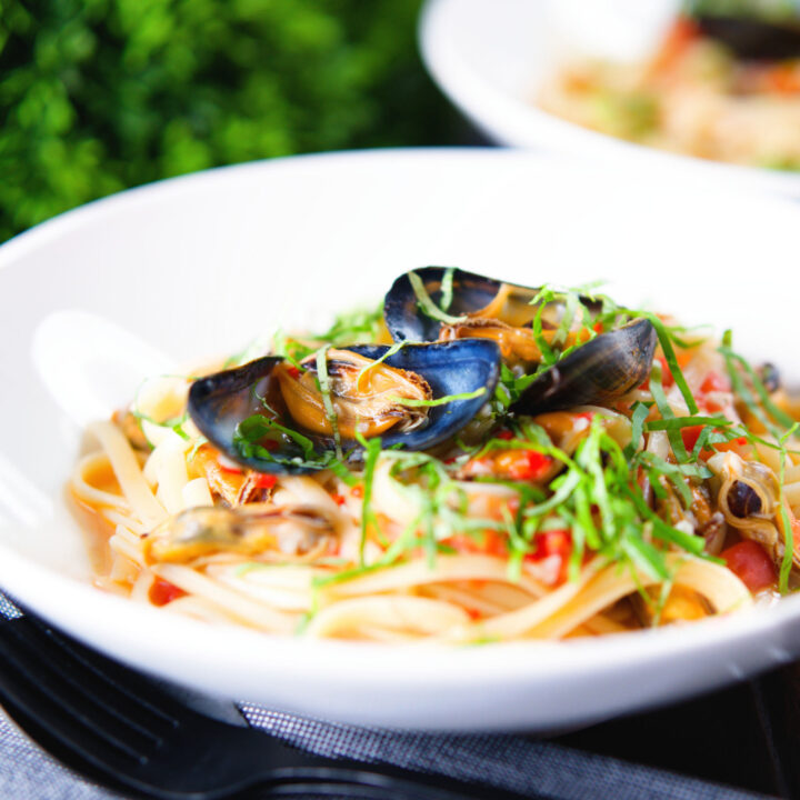 Pasta (linguine) with mussels in white wine with garlic, chilli and tomatoes.