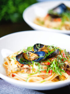 Mussels with pasta (linguine) in butter and white wine with garlic, chilli and tomatoes.