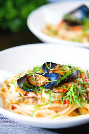 Mussels with pasta (linguine) in butter and white wine with garlic, chilli and tomatoes.