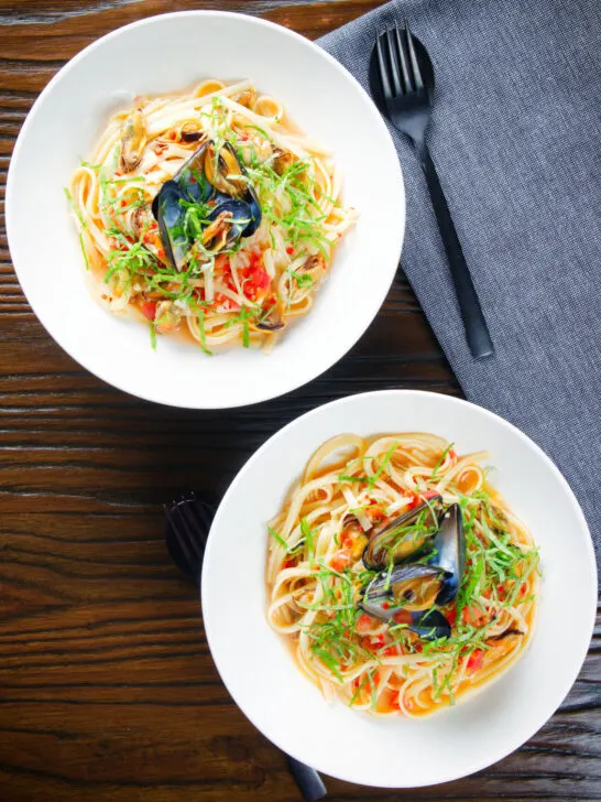 Overhead mussels with pasta (linguine) in butter and white wine with garlic, chilli and tomatoes.