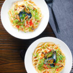 Overhead mussels with pasta (linguine) in butter and white wine with garlic, chilli and tomatoes.