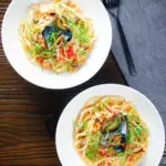 Overhead mussels with pasta (linguine) in butter and white wine with garlic, chilli and tomatoes.