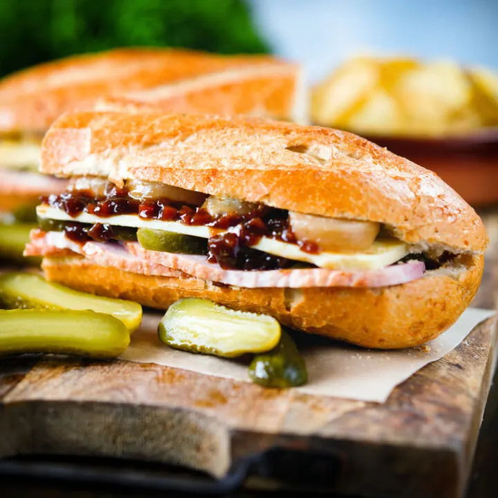 Ploughman's lunch sandwich with ham, cheese, pickled onions and Branston Pickle.