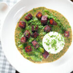Overhead crispy tofu Thai green curry with fresh herbs and jasmine rice.
