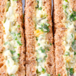 Close-up boiled egg and cress sandwiches with mayonnaise on wholemeal seeded bread.
