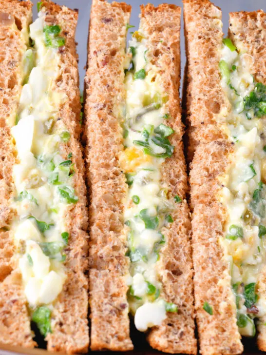 Close-up boiled egg and cress sandwiches with mayonnaise on wholemeal seeded bread.