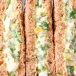 Close-up boiled egg and cress sandwiches with mayonnaise on wholemeal seeded bread.