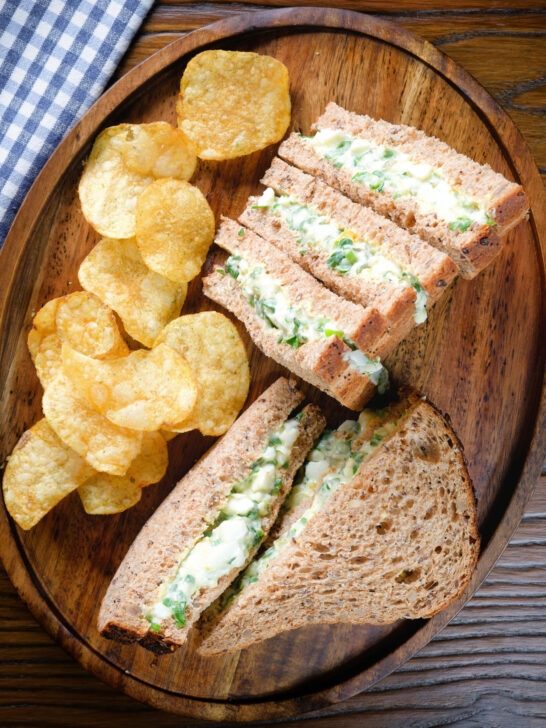 Overhead boiled egg and cress sandwiches with mayonnaise on wholemeal seeded bread.