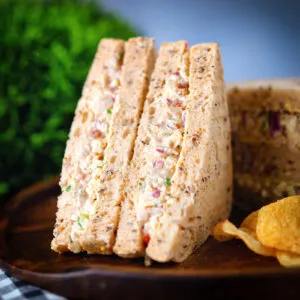 Cheese and onion sandwich with Branston pickle served with crisps and pickled onions.
