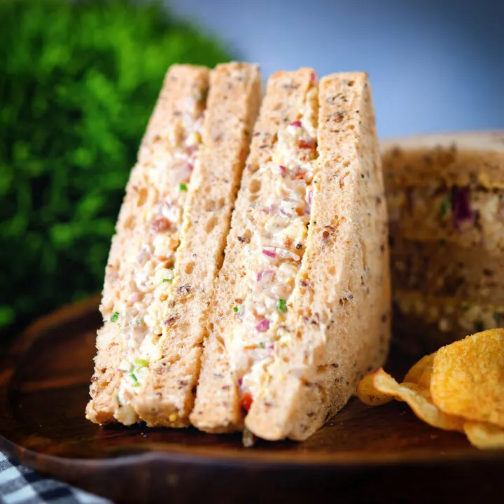 Cheese and onion sandwich with Branston pickle served with crisps and pickled onions.