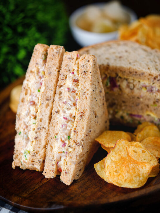 Cheese and onion sandwich with Branston pickle on malted bread served with crisps.
