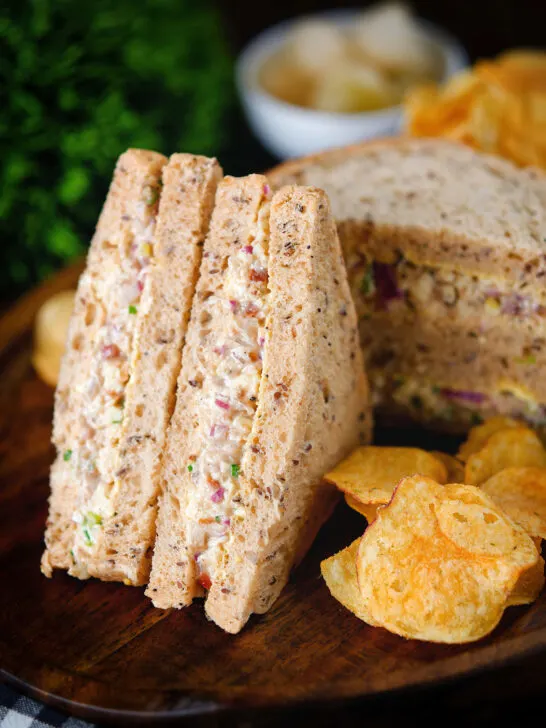Cheese and onion sandwich with Branston pickle on malted bread served with crisps.