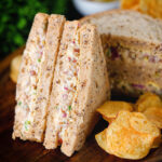 Cheese and onion sandwich with Branston pickle on malted bread served with crisps.