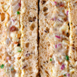 Close-up cheese and onion sandwich with Branston pickle on malted bread.